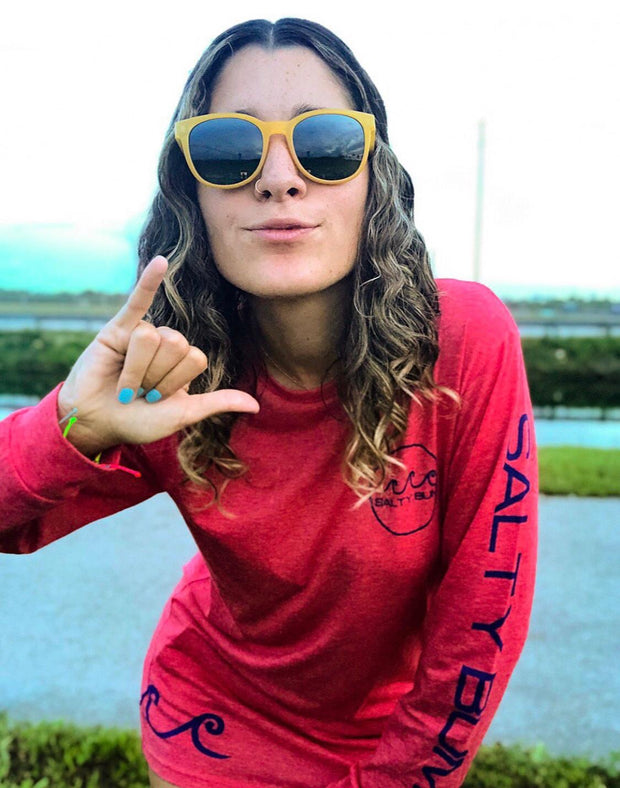 The Salty Bum Ladies Shaka Tee is a long sleeve t-shirt that features the Salty Bum Logo on the front, a wavy shaka design on the back, and our three signature waves on the bottom right side. This tee is made of 100% cotton to provide an extreme softness and a custom fit.